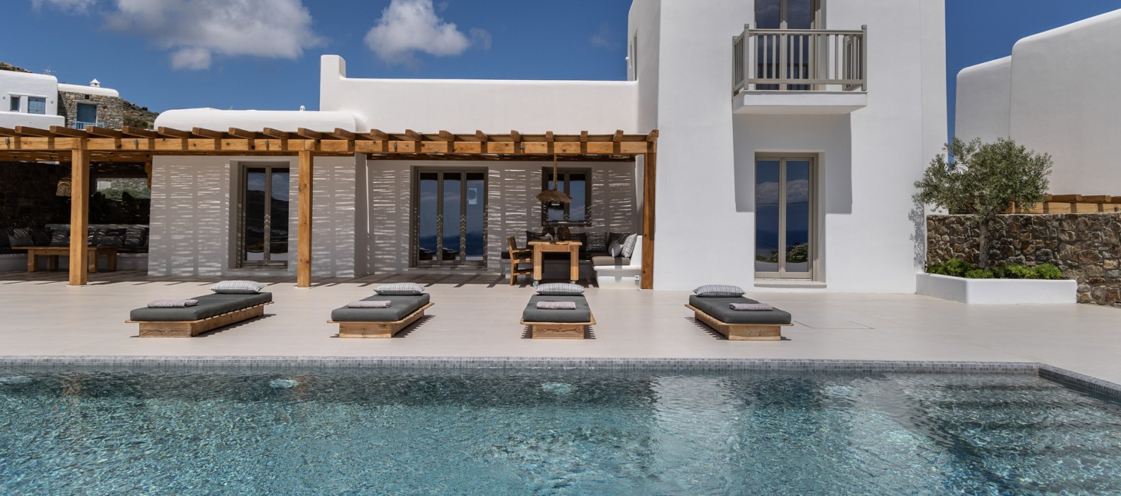 Exterior villa with pool and sun loungers of Villa Golden Elena in Mykonos