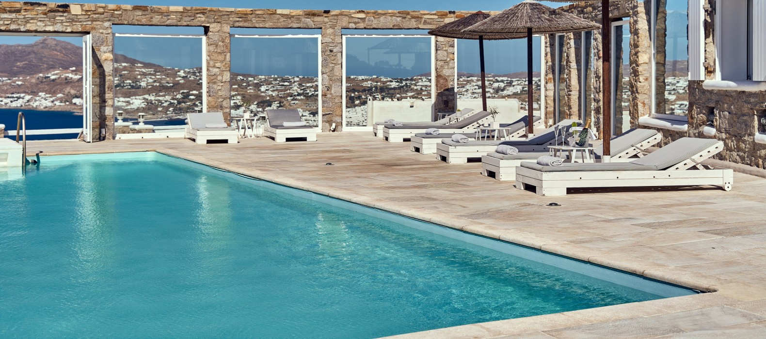 Exterior pool area with sun loungers of Villa Mura Mura in Mykonos