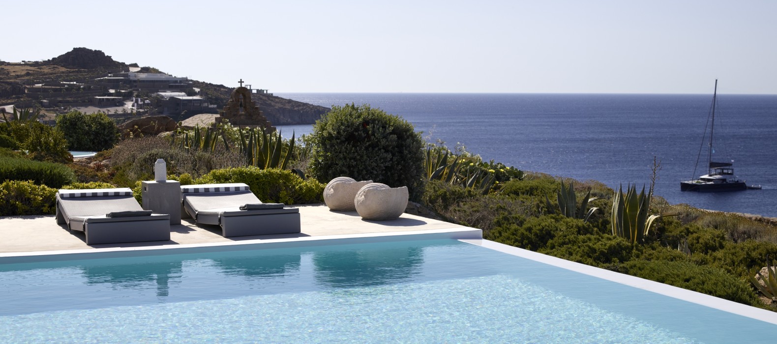 Exterior pool area with sea view of Villa Posidonia in Mykonos