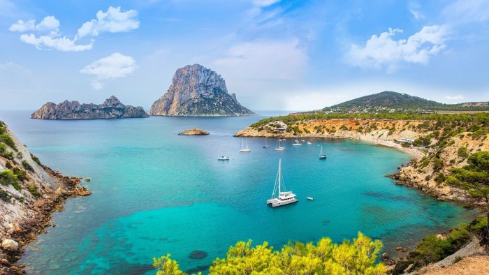 TOM BENZON - View over a wonderful bay and the magical rock Es Vedra in Ibiza.