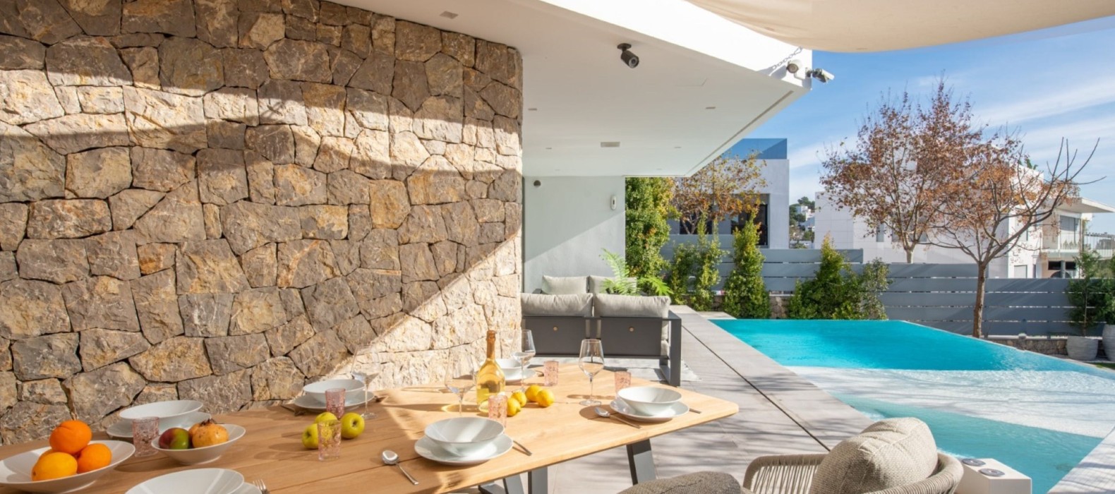 Exterior dining area next to the pool of Casa Oleta in Ibiza