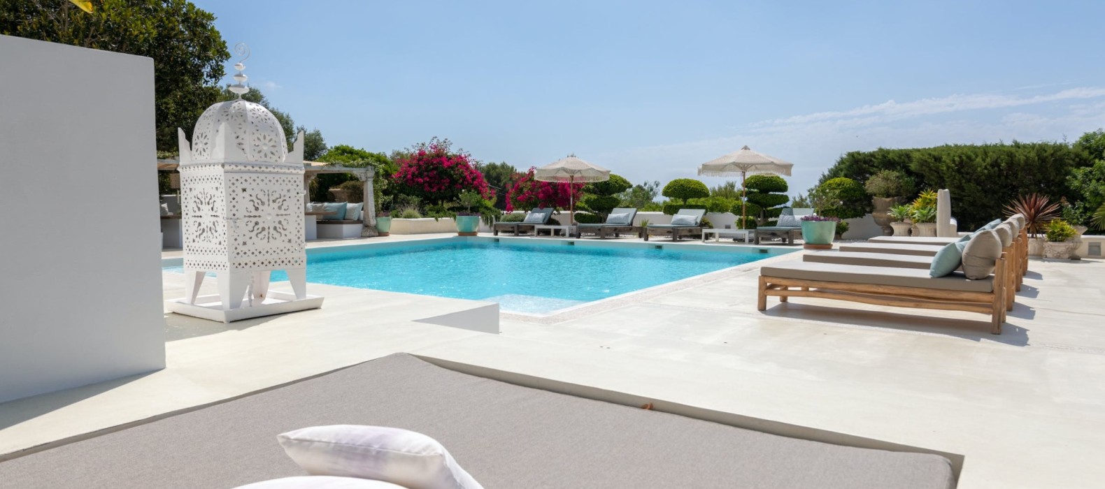 Exterior pool area with sun loungers of Villa Glamour in Ibiza