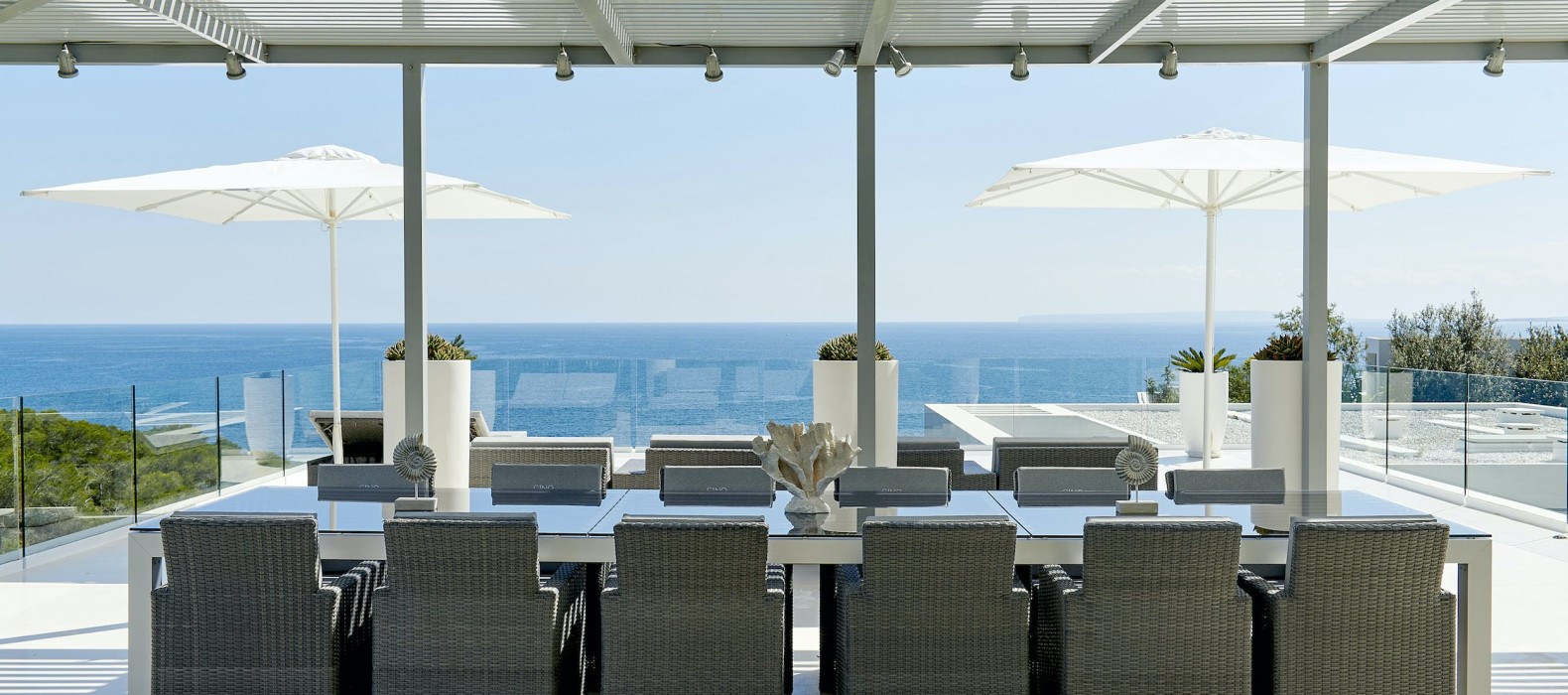 Exterior dining table with sea view of Villa La Colina. Ibiza