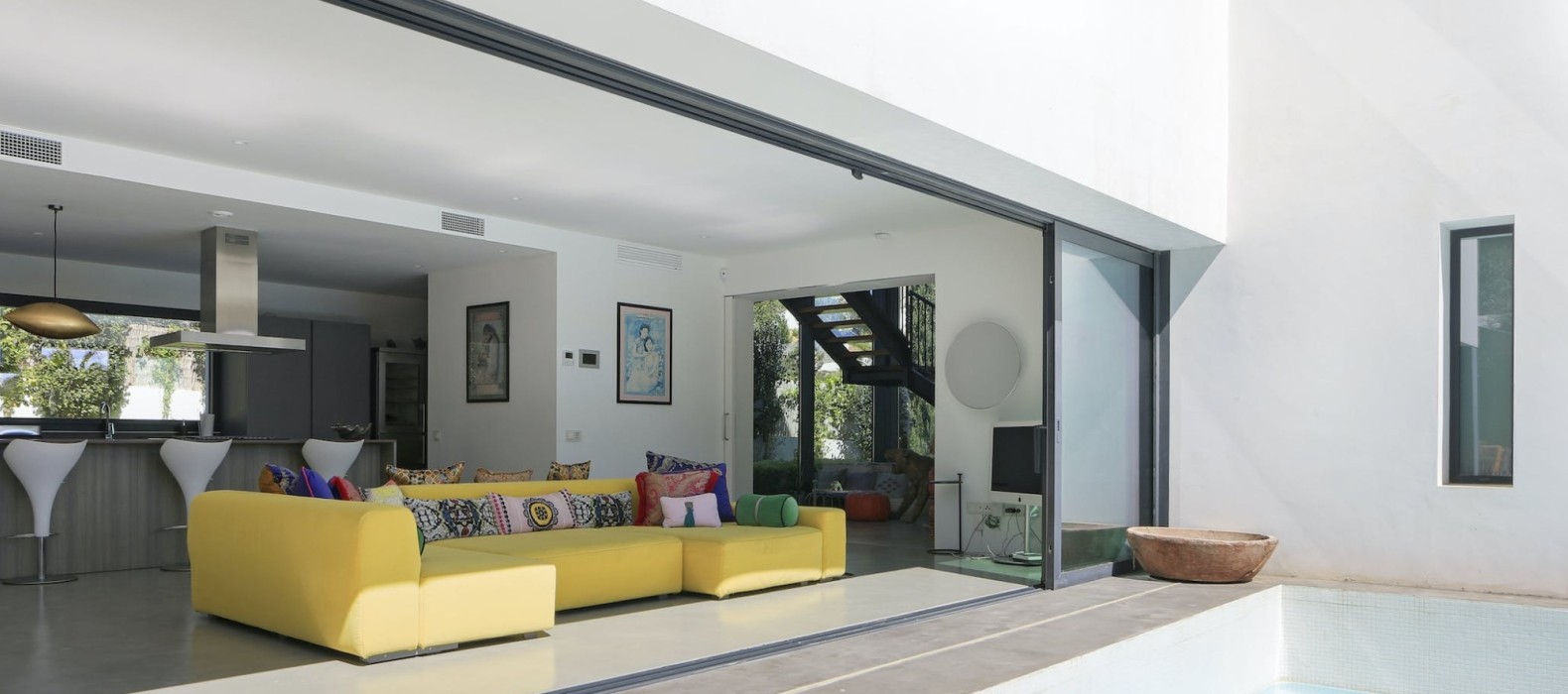 Exterior view of the living room next to the pool of Villa Love and Light in Ibiza