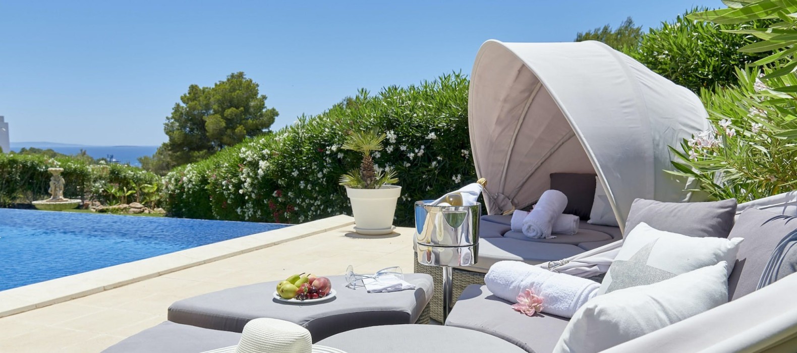 Daybeds next to the pool of Villa Riva Alto in Ibiza