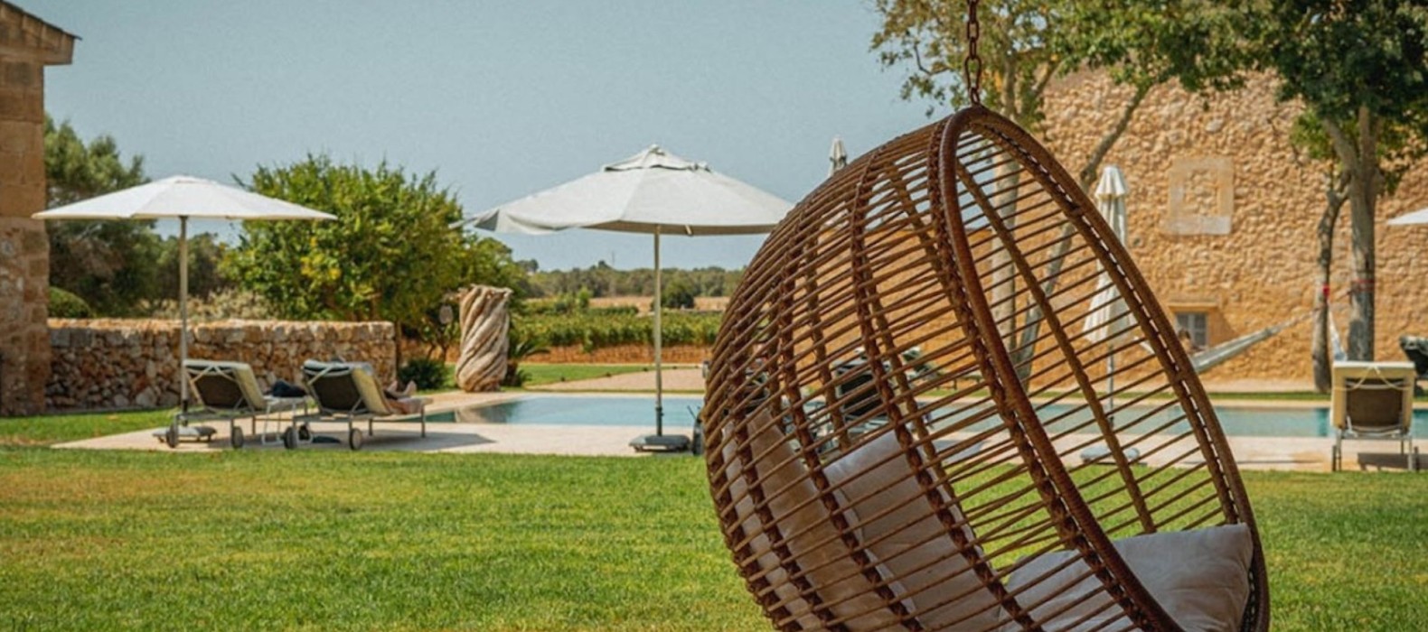 Outdoor pool area hanging chair of Finca Solene in Mallorca